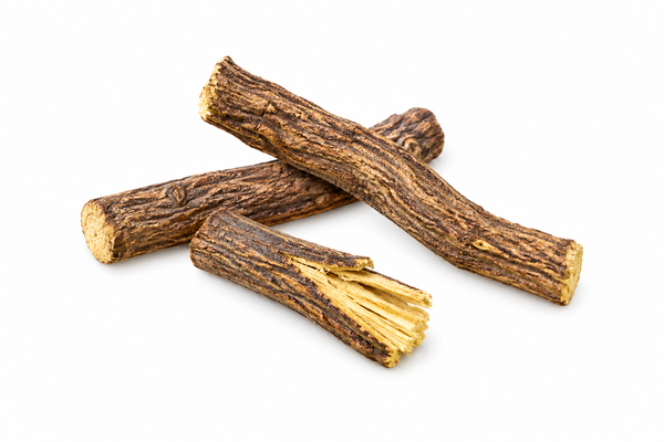 Whole licorice roots with one split pale-yellow fibrous interior.