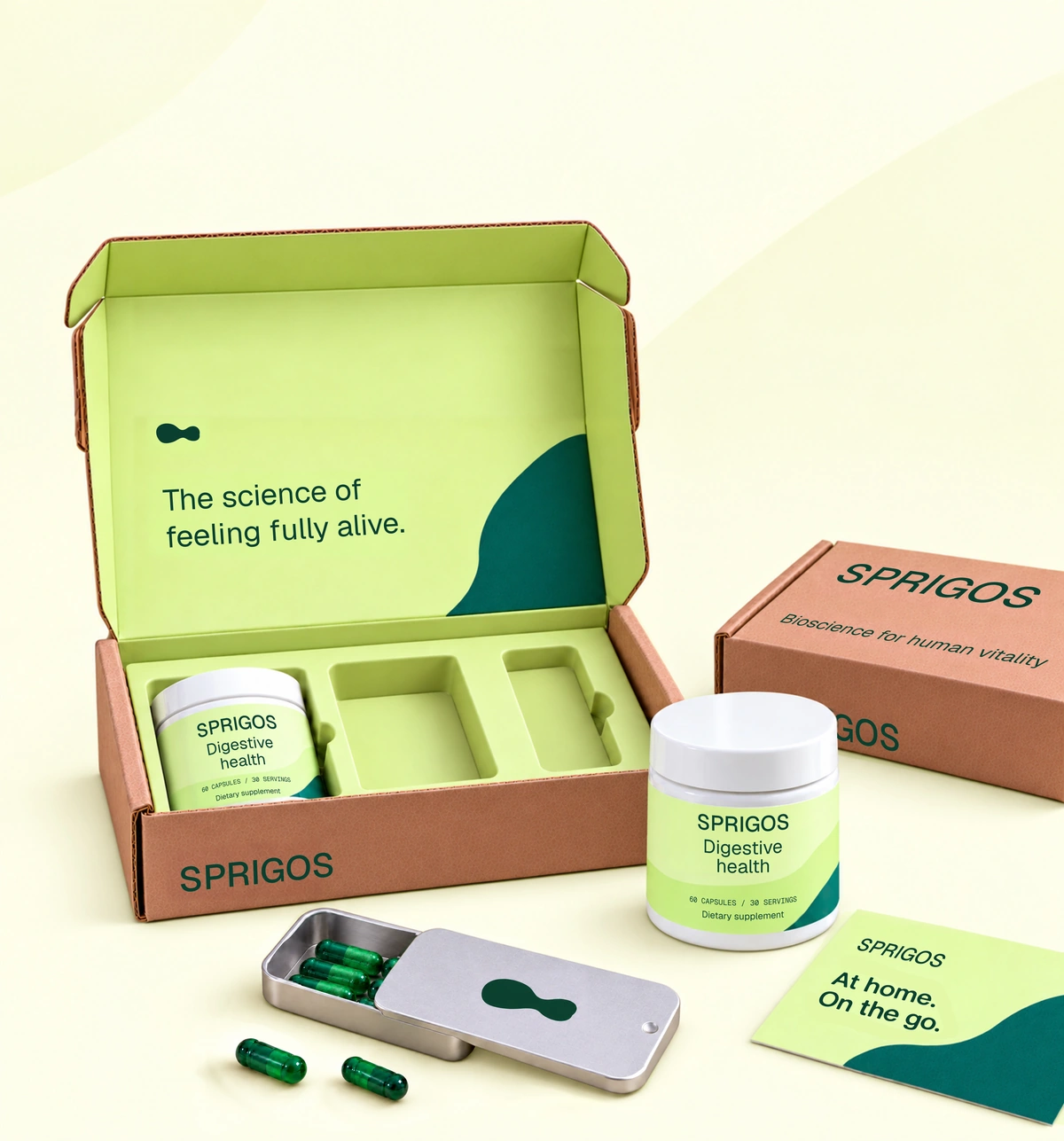 Sprigos packaging with an open citrus-lined mailer, two white jars, a silver travel tin, green capsules, a closed mailer and an At home. On the go. insert card.